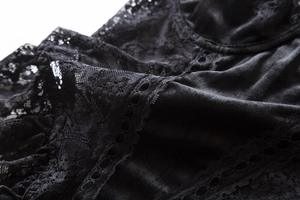 Macro shot of black velvet lace bodysuit featuring intricate floral embroidery and fabric texture