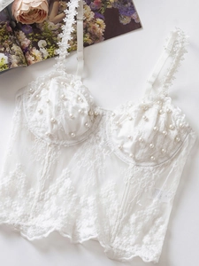 Detail of white lace corset with pearl beads, floral lace straps and satin sizing label