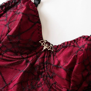 Gothic spiderweb lace camisole in red satin with a vintage metal bat pendant detail
