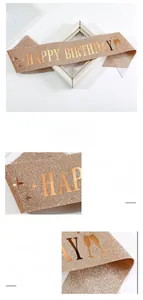 Macro detail of glittery champagne gold Happy Birthday sash with metallic lettering