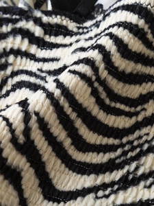 Macro view of textured zebra print fabric and fine knit stitching on y2k camisole