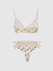 Detail of champagne mesh lingerie set with green floral embroidery and adjustable straps