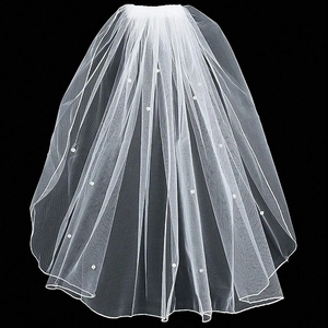 Close-up of white layered bridal veil with delicate pearl accents on fine mesh tulle fabric