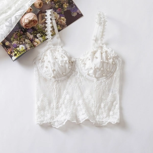 Elegant white lace corset top with pearl embellishments and sheer floral embroidery