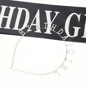 Close-up of silver metal Birthday Girl headband with glitter finish for party