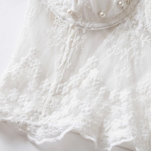White lace corset top with floral embroidery, sheer mesh panels and pearl accents