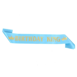 Close-up of sky blue satin sash with gold Birthday King lettering and crown icons