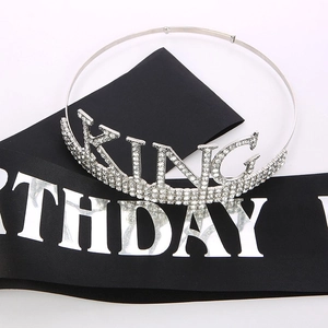 Detail of silver Birthday King rhinestone crown and black silk sash for men's party decor
