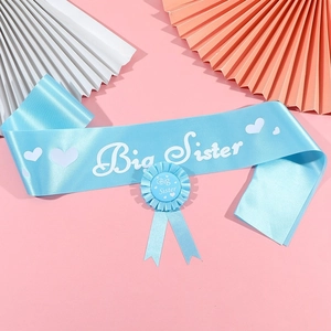 Detail of blue Big Sister sash and rosette set for baby shower celebrations