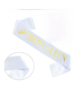 Detail of white satin sash with gold foil Prom Queen lettering and crown texture