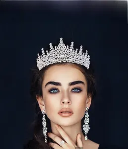Close-up of elegant silver crystal crown and long fringe earrings for birthday queens