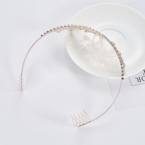 Elegant rose gold bridal crown with sparkling crystals and side combs on white background
