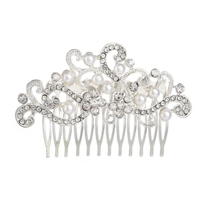 Detailed close-up of bridal hair comb with pearls, rhinestones and silver floral scrollwork