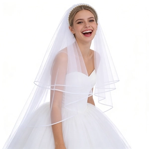 Elegant white pearl headband with long multi-layer bridal veil on a clean background