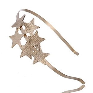 Detail of gold headband featuring textured five-pointed stars with metallic finish
