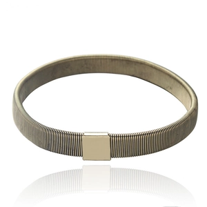 Detail view of elastic metal spring sleeve garter in champagne gold finish