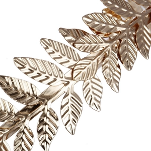Macro shot of detailed golden metal leaf texture on Baroque bridal hair accessories