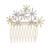 Detail view of golden hair comb with sparkling crystals and star motifs for bridal hair