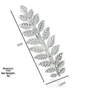 Detail showing metallic leaf hair clip dimensions 9cm by 3.3cm on white background