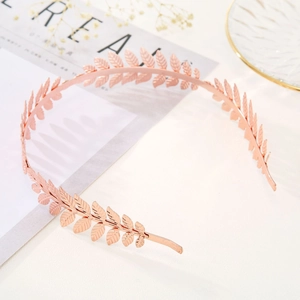 Elegant rose gold leaf headband for brides with metallic leaf textures on white background