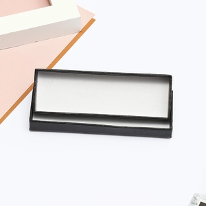 Macro view of rectangular black matte gift box with white interior and lid structure