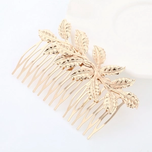 Detailed macro view of golden leaf bridal hair comb with fine texture and 14-teeth structure