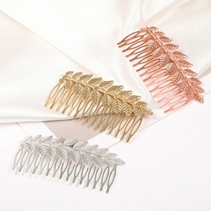Elegant leaf-shaped hair combs in gold, silver, and rose gold finishes on satin