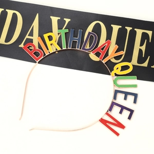 Close-up of a colorful BIRTHDAY QUEEN rhinestone headband with a sleek gold ribbon set