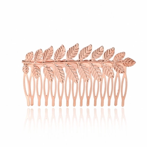 Detail showing rose gold leaf hair comb with textured veins and polished metal finish