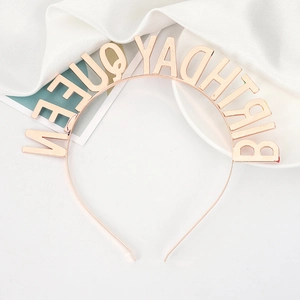 Close-up of rose gold metal headband with Birthday Queen lettering and glossy finish
