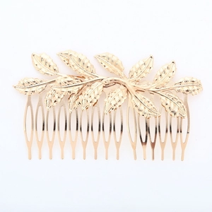 Close-up of golden leaf hair comb with detailed textures and polished metallic finish