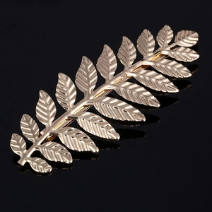 Macro close-up of golden leaf headband showing detailed metallic texture and shine