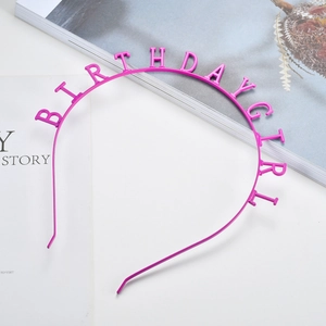 Detailed view of the fuchsia Birthday Girl lettering on a metallic party headband