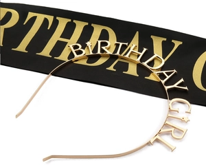 Detailed view of a gold metal Birthday Girl headband with decorative stars and sash