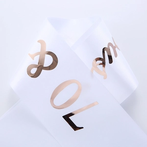 Close-up of white satin Prom sash featuring elegant rose gold foil lettering detail