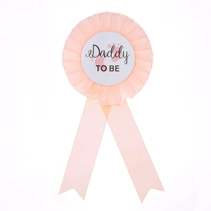 Baby shower tinplate badge featuring Daddy To Be text and pink ribbon for parties
