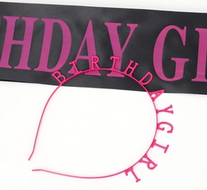 Close-up of hot pink Birthday Girl headband and black satin sash for birthday party