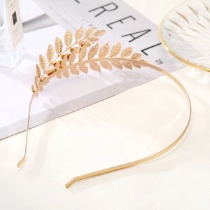 Detailed view of a golden metal leaf headband with fine textures for bridal hair styling