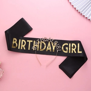 Détail de l'inscription BIRTHDAY GIRL dorée sur écharpe satin noire et serre-tête