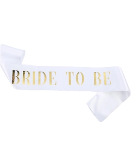 Close-up of white satin sash with gold foil Bride to be lettering for bridal parties