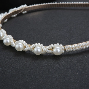 Elegant gold metal headband for women featuring handcrafted pearls in a wavy pattern