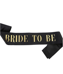 Detail of black satin sash with gold foil Bride to be lettering for bachelorette parties