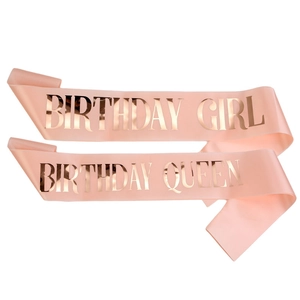 Detail of pink satin sashes with rose gold Birthday Queen lettering for birthday parties