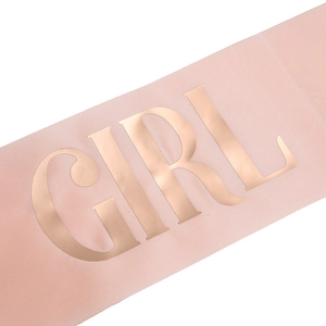 Close-up of pink satin birthday girl sash with elegant rose gold foil lettering detail