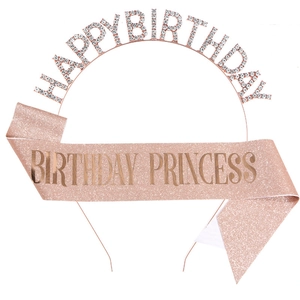Close-up of rose gold rhinestone birthday headband and pink glitter princess sash