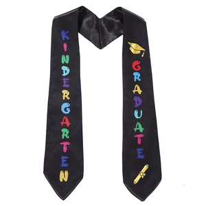 Black satin kindergarten graduation sash with rainbow lettering and golden cap icon
