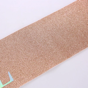 Macro shot of rose gold glitter birthday sash with holographic text detail and sequins