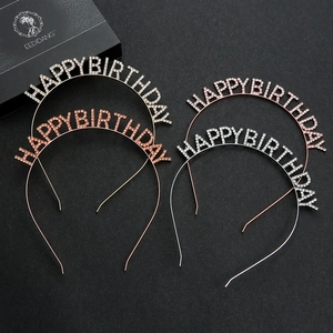 Close-up of four rhinestone birthday headbands with Happy Birthday lettering in silver and rose gold