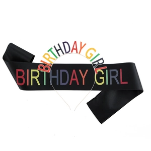 Detail of black satin sash and metal headband with rainbow Birthday Girl lettering