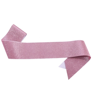 Close-up of pink glitter sash fabric texture showing sparkling silver sequins and fiber